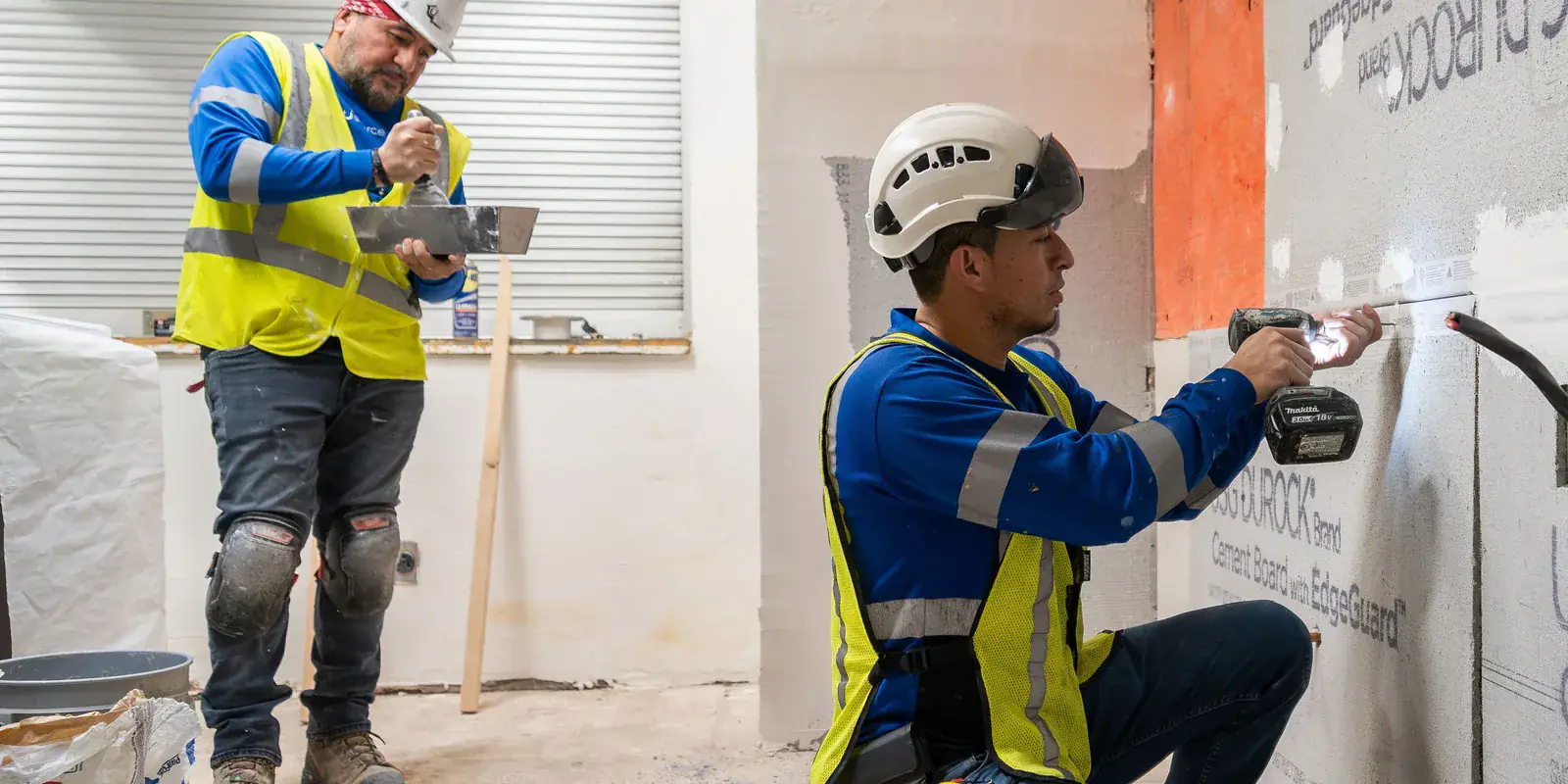 Usource Construction crew installing cement board on an interior wall