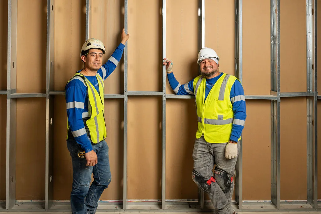 Two of the crew inside a partition under construction