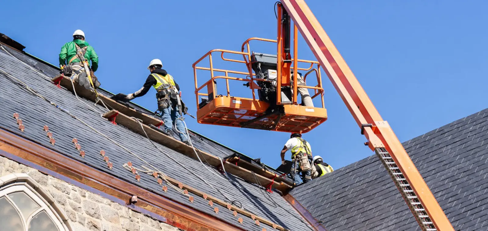 Usource crew working on a historic roof