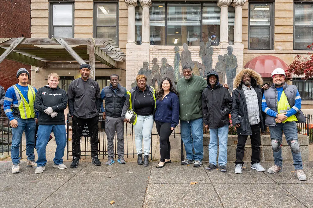 Usource crew with Christ House staff outside the building