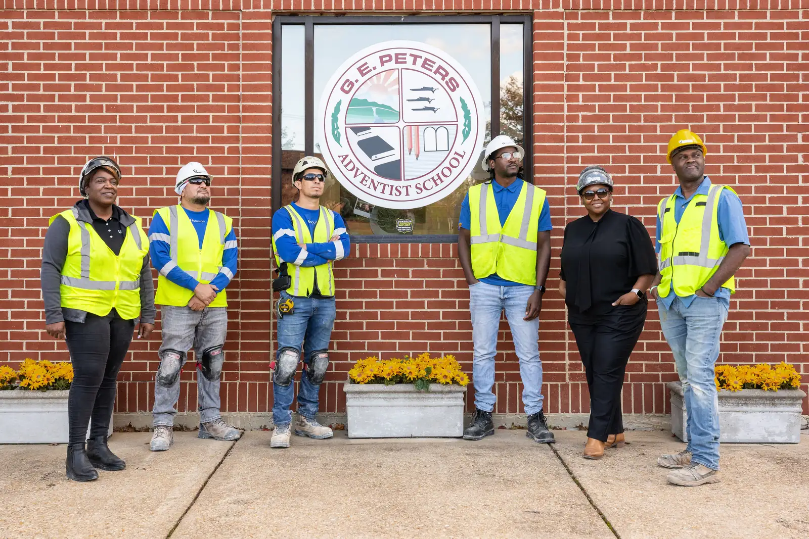 The Usource Construction crew outside G.E. Peters Adventist School