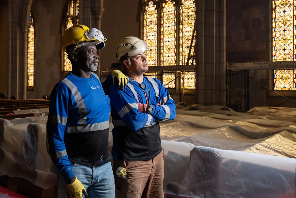 Two of the crew in the sanctuary with the pews sheeted over