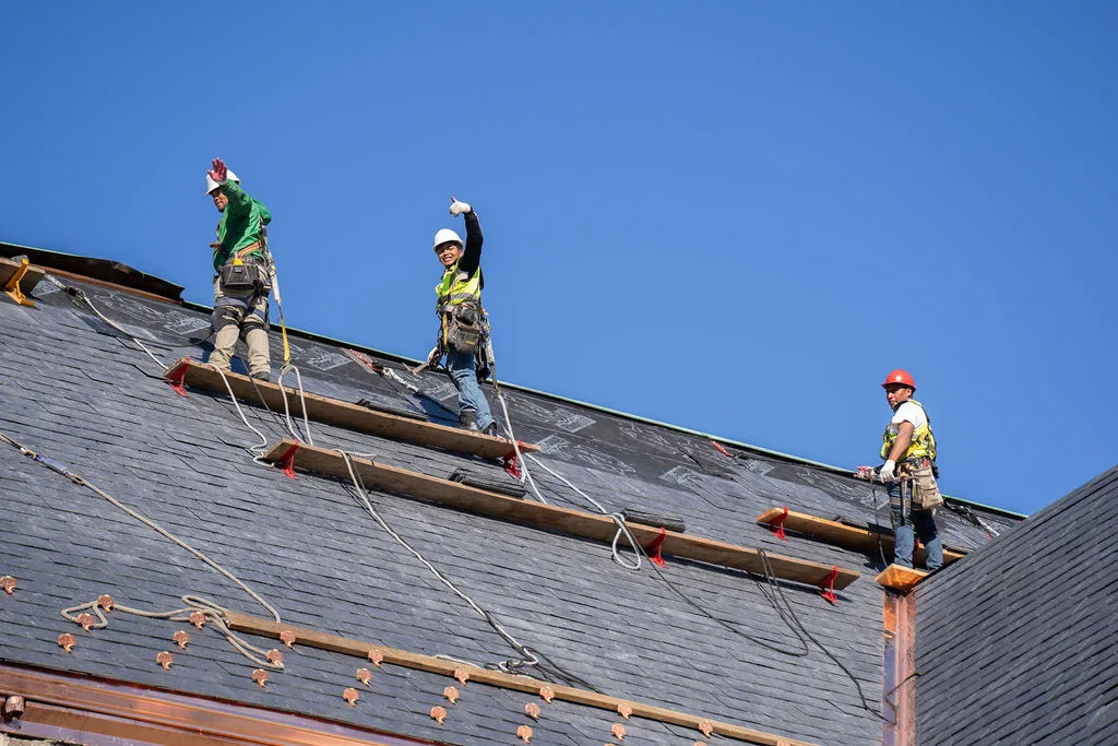 Roofers and new copper work along the eaves