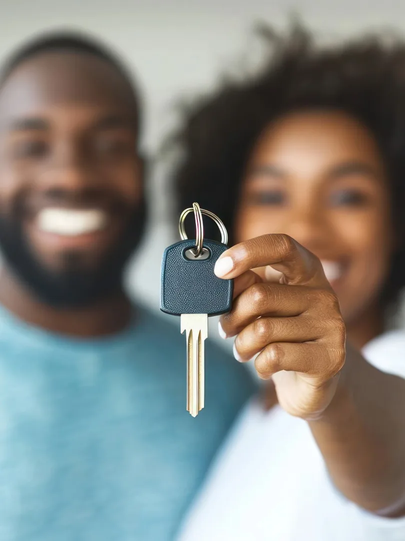 A couple holding the key to their new home