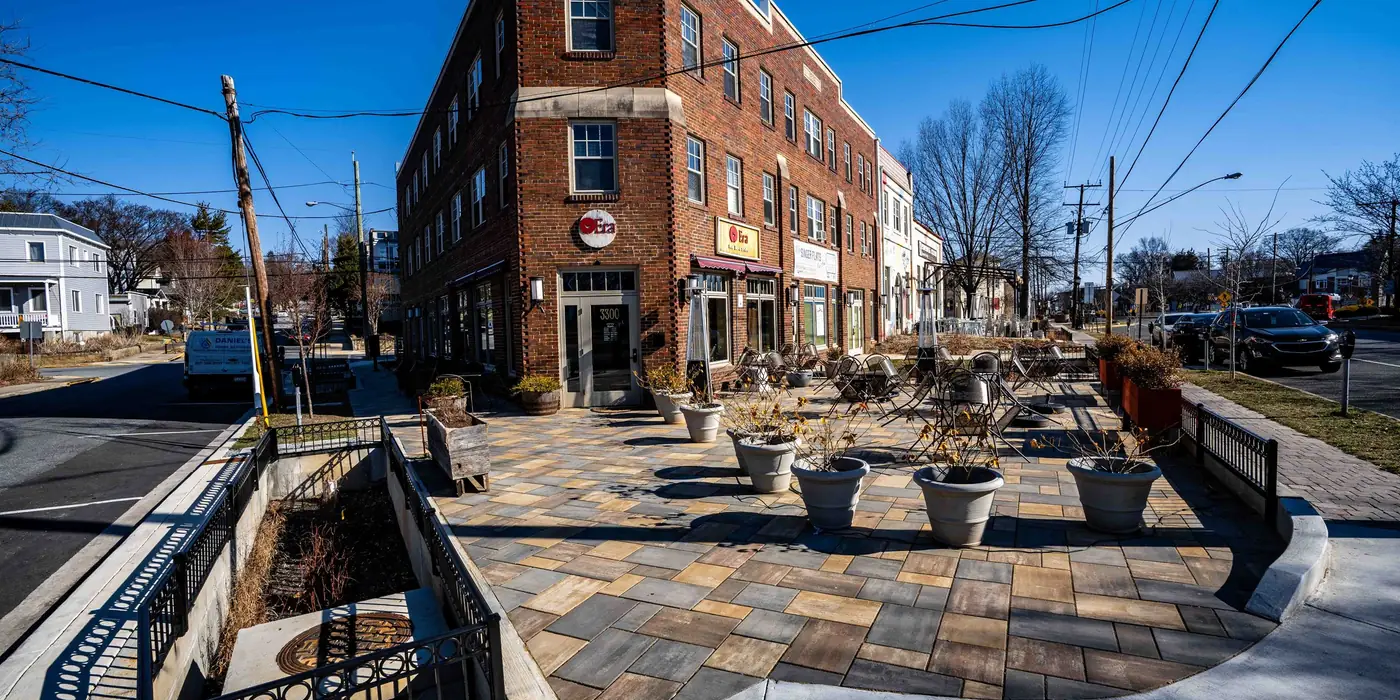 New plaza, planters and stepped seating beside the corner building