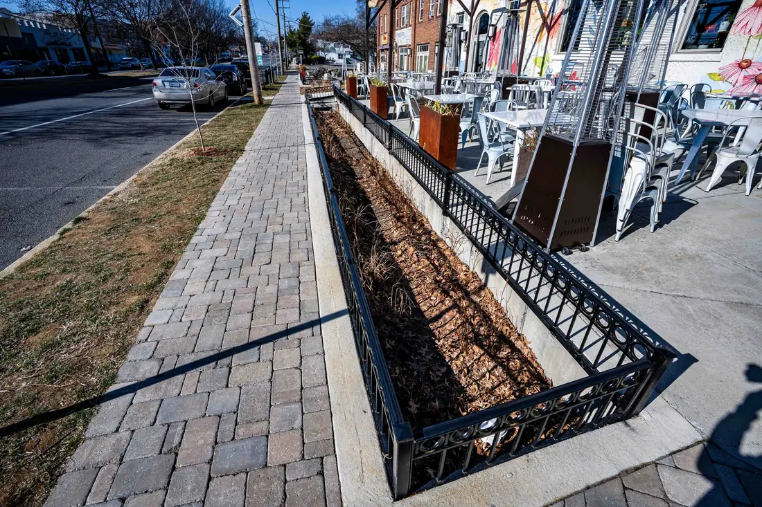 Micro-bioretention facility and railing alongside the new paver sidewalk