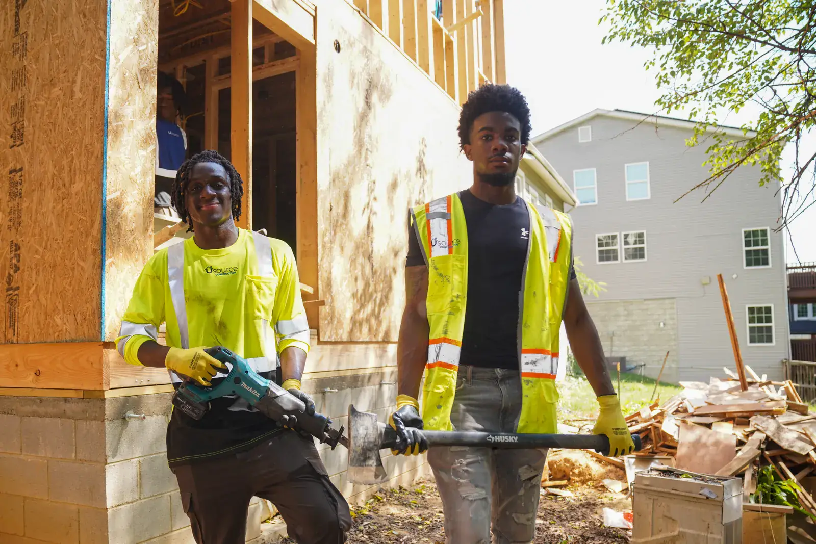 Two Usource crew members working on the exterior