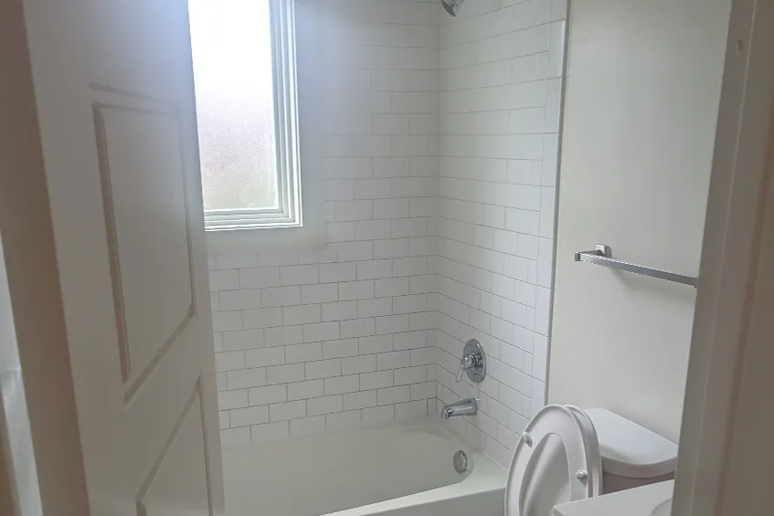 Renovated bathroom with new tub surround and fixtures
