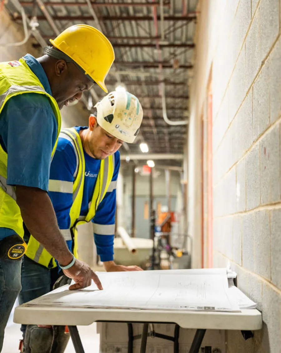 Usource superintendent reviewing project drawings on site